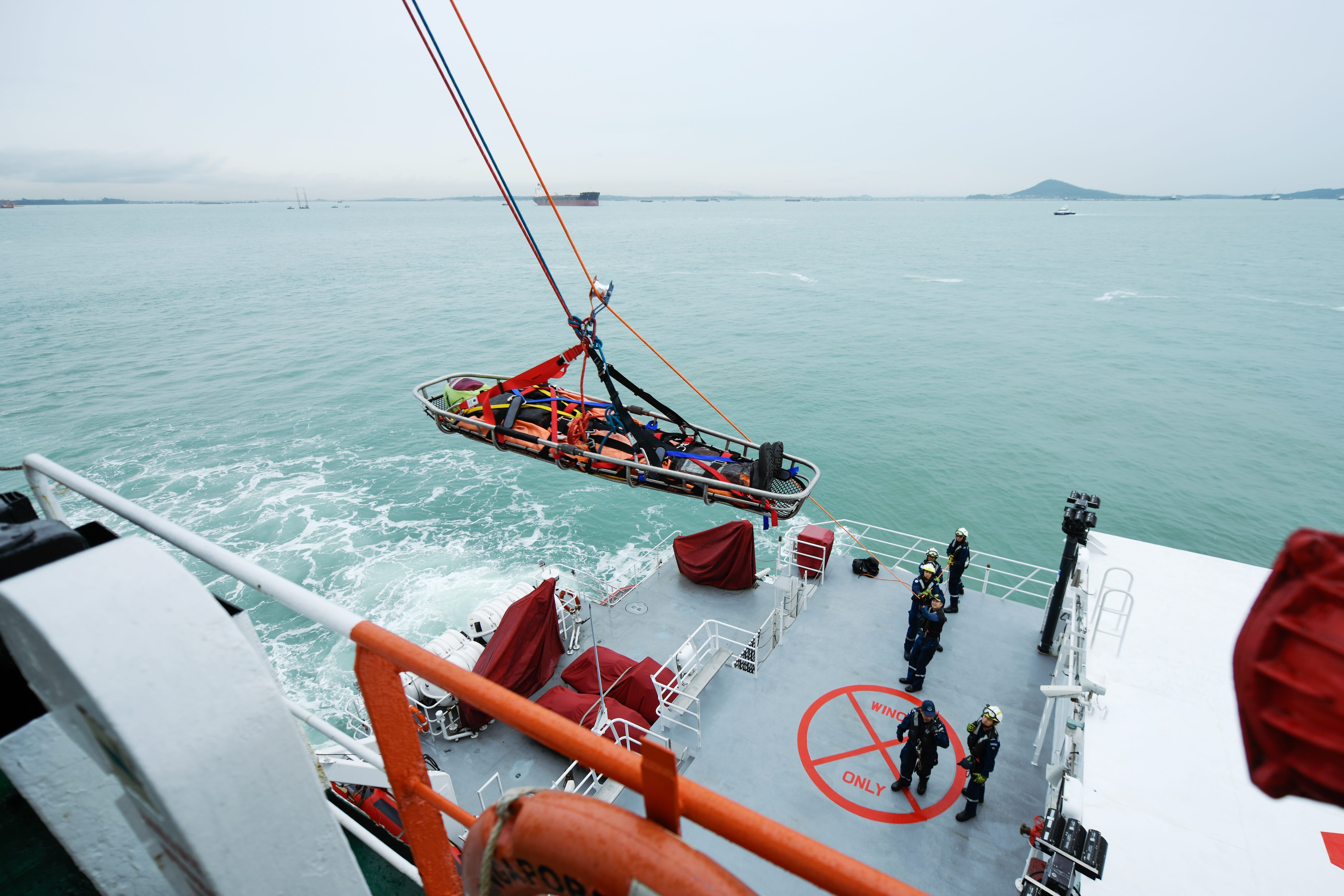 SCDF personnel conducting casualty evacuation from the hijacked vessel and bringing them to safety.